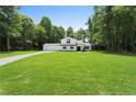 This two-story home shows manicured lawn, mature trees, a long driveway and great curb appeal at 3729 Meadow Glen Cir, Ellenwood, GA 30294