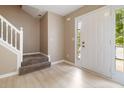 Bright foyer with hardwood floors, a white door with glass, and staircase at 4783 Creekside Pl, Decatur, GA 30035