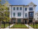 Charming two-story townhome with brick accents, a fenced yard, and a well-manicured lawn at 5440 Howington Ct # 190, Buford, GA 30518