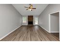 Spacious living room featuring modern flooring and a brick fireplace at 5514 E Stoneway Ct, Villa Rica, GA 30180