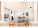 Cozy living room with fireplace, built-in shelving, wood floors, and neutral decor at 220 Renaissance Ne Pkwy # 1105, Atlanta, GA 30308