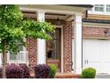 Detailed view of the front door, brick facade, and manicured landscaping around this home at 281 Green Hill Rd, Atlanta, GA 30342