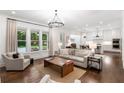 Open-concept living area with hardwood floors, neutral decor, and seamless connection to the kitchen at 281 Green Hill Rd, Atlanta, GA 30342