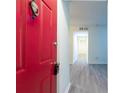 Inviting entryway featuring new grey flooring and a bright red door at 1201 Old Hammond, Atlanta, GA 30350