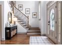 Bright foyer with hardwood floors, staircase, and decorative mirror, creating a welcoming entrance at 2314 Tall Timbers Ln, Marietta, GA 30066