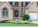 Close-up of the home's front entrance, featuring a stone walkway and beautiful landscaping at 2314 Tall Timbers Ln, Marietta, GA 30066