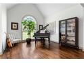 Elegant living room with a grand piano, hardwood floors, and lots of natural light at 2314 Tall Timbers Ln, Marietta, GA 30066