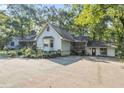 View of a light blue home with lush landscaping and a separate garage or additional living space at 2371 Leguin Mill Rd, Locust Grove, GA 30248