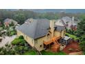 Back of house with deck, screened-in room, with plenty of mature trees, grass, and privacy at 8108 Greens Mill Way, Loganville, GA 30052