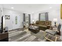 Inviting living room with modern gray walls, wood floors, and natural light from the two windows at 2860 Jefferson St, Austell, GA 30106