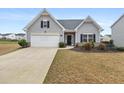 Charming home with a well-manicured lawn and a paved driveway leading to a two-car garage at 4470 Madison Hall Dr, Cumming, GA 30028
