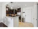 Open kitchen with stainless steel appliances, stylish pendant lighting, and tiled flooring at 1101 Juniper Ne St # 1012, Atlanta, GA 30309