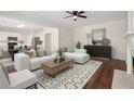 Cozy living room features hardwood floors, fireplace, and ample seating at 153 Towey Trl, Woodstock, GA 30188
