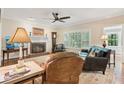 Inviting living room with cozy fireplace, plush seating, and natural light from large window at 2819 Saddlebrook Nw Way, Marietta, GA 30064