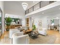 Bright, open-concept living room seamlessly connecting to the modern kitchen, with soaring ceilings at 1430 N Harris Rdg, Atlanta, GA 30327