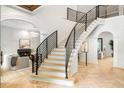 Elegant staircase featuring sleek black railings, light wood steps, and stylish architectural design at 1430 N Harris Rdg, Atlanta, GA 30327
