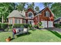 Charming brick home with manicured lawn, bench seating, and beautiful landscaping at 2633 Hanriva Ct, Dacula, GA 30019