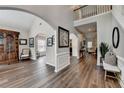 Open-concept foyer featuring hardwood floors, neutral walls, archways, and a staircase at 2633 Hanriva Ct, Dacula, GA 30019