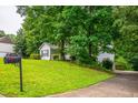 Well-maintained home with mailbox, driveway, and established trees at 305 Saddle Wood Dr, Canton, GA 30114