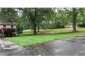 Lush, green lawn and mature shade trees surround the home at 4845 Willow St, Acworth, GA 30101