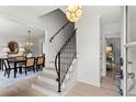 Bright entryway features staircase with iron railing and hardwood floors, adjacent to dining area at 600 Delphinium Nw Blvd, Acworth, GA 30102