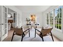 Sunlit home office with neutral colors, French doors, and stylish decor creates a productive workspace at 600 Delphinium Nw Blvd, Acworth, GA 30102