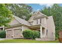 Charming traditional home with a two-car garage, well-maintained lawn, and mature landscaping at 2366 Proctor Creek Enclave, Acworth, GA 30101