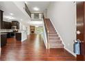 Welcoming foyer featuring hardwood floors, a staircase, and views of the open floor plan at 2366 Proctor Creek Enclave, Acworth, GA 30101