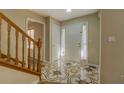 Bright foyer showcasing tile flooring, a staircase with wooden railing, and a welcoming entrance at 2436 Green Hollow Ct, Conyers, GA 30012