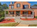 Close-up view of the home's inviting front porch with decorative railings and a well-maintained garden at 2436 Green Hollow Ct, Conyers, GA 30012