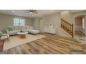 Staged living room with hardwood floors, large windows, and cozy furniture, perfect for relaxation at 2436 Green Hollow Ct, Conyers, GA 30012