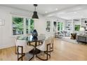 Bright dining area with hardwood floors, modern lighting, and a view to a cozy seating area at 1168 Mclynn Ne Ave, Atlanta, GA 30306