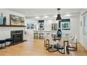 Open-concept living with modern lighting, gas fireplace and a glimpse of the well-appointed kitchen at 1168 Mclynn Ne Ave, Atlanta, GA 30306