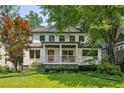 Charming home with a welcoming front porch, manicured lawn, and a combination of painted brick and siding at 1168 Mclynn Ne Ave, Atlanta, GA 30306