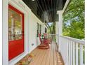 Inviting front porch with wooden floors, white railings, and red rocking chairs, enhancing curb appeal at 1168 Mclynn Ne Ave, Atlanta, GA 30306