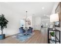Bright dining room with modern chandelier, wood floors, round table, and stylish decor at 150 Chandler Trce, Covington, GA 30016