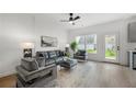 Cozy living room with comfortable seating, ceiling fan, and natural light filtering in at 150 Chandler Trce, Covington, GA 30016