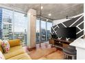 Stylish living room with hardwood floors, modern decor, and city view balcony at 3324 Peachtree Ne Rd # 1813, Atlanta, GA 30305