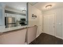 Welcoming entryway featuring dark wood floors, white door and trim, and a kitchen view at 2700 Pine Tree Ne Rd # 1013, Atlanta, GA 30324
