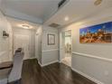 Hallway view showcasing hardwood floors, gray walls, white trim, and bathroom access at 2700 Pine Tree Ne Rd # 1013, Atlanta, GA 30324