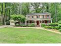 Charming two-story home with red shutters, white trim and a well-manicured lawn at 5507 Martina Way, Dunwoody, GA 30338