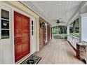 View of the front porch with a brick accent wall and a wood plank floor, inviting entrance at 5507 Martina Way, Dunwoody, GA 30338