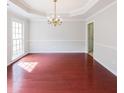 Elegant dining room with hardwood floors, wainscoting, and a chandelier for intimate gatherings at 780 Karingway Nw Ln, Kennesaw, GA 30152