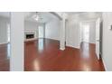 Spacious living room with hardwood floors, fireplace, large window, and an open floor plan at 780 Karingway Nw Ln, Kennesaw, GA 30152