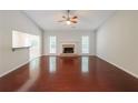 Inviting living room features fireplace, large windows, and open floor plan at 780 Karingway Nw Ln, Kennesaw, GA 30152