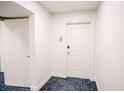 Hallway with white door, baseboards, and carpet with geometric design at 270 17Th Nw St # 3804, Atlanta, GA 30363