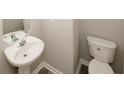Cozy half bath with stylish pedestal sink and modern fixtures at 365 Hunt Creek Dr, Acworth, GA 30101