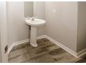 Cozy half bath with stylish pedestal sink and modern fixtures at 365 Hunt Creek Dr, Acworth, GA 30101