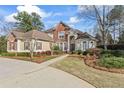 Stunning front exterior featuring lush landscaping and a welcoming driveway at 612 Champions Dr, Mcdonough, GA 30253