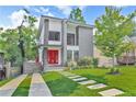 Stylish two-story home featuring a red front door, landscaped yard, and modern architectural design at 120 Vanira Se Ave, Atlanta, GA 30315